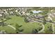 Aerial view of the Hampton Walk community with houses, community pool, pond, playground and green space at 7308 Broadview Ln, McCordsville, IN 46055
