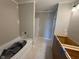 Bathroom featuring a tub/shower combo, light-colored walls, and unfinished cabinets at 7308 Broadview Ln, McCordsville, IN 46055