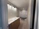 Bathroom featuring double sinks, a shower/tub combo, modern vanity lighting, and light-colored walls at 7308 Broadview Ln, McCordsville, IN 46055