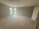 Bedroom featuring light-colored walls, an unfinished floor, and bright, natural light from the windows at 7308 Broadview Ln, McCordsville, IN 46055