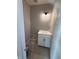 Powder room featuring a white cabinet with a white countertop, dark hardware, and a modern light fixture at 7308 Broadview Ln, McCordsville, IN 46055