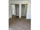 Carpeted bedroom features dual mirrored closets and a door to the exterior at 7411 Country Brook Dr, Indianapolis, IN 46260