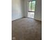 Bright bedroom features neutral carpeting and a large window with treetop views at 7411 Country Brook Dr, Indianapolis, IN 46260