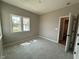 Bright bedroom with neutral carpeting, paint, and a window that offers natural light and scenic views at 7421 Broadview Ln, McCordsville, IN 46055