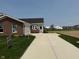 Charming brick home featuring a long driveway, well-manicured lawn, and attached two-car garage at 7421 Broadview Ln, McCordsville, IN 46055