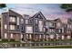Street view of new townhomes with brick and siding, multi-paned windows, and covered entrances at 7421 Broadview Ln, McCordsville, IN 46055