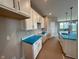 Modern kitchen with white cabinets, countertops, stainless steel sink, and pendant lighting at 7421 Broadview Ln, McCordsville, IN 46055