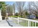 Wide backyard view from the deck looking onto a fenced yard and mature trees at 7624 Snowflake Dr, Indianapolis, IN 46227