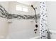 Bright bathroom featuring white subway tile with decorative accent stripe and dark fixtures at 7624 Snowflake Dr, Indianapolis, IN 46227