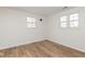 Bright bedroom featuring two windows and clean, modern flooring at 7624 Snowflake Dr, Indianapolis, IN 46227