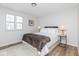 Inviting bedroom featuring warm wood floors, a cozy bed, and lots of natural light at 7624 Snowflake Dr, Indianapolis, IN 46227