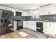 Modern kitchen with white cabinets, black appliances, and a blue tiled backsplash for a sleek design at 7624 Snowflake Dr, Indianapolis, IN 46227