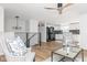 Open-concept living space with hardwood floors and seamlessly connected to the modern kitchen at 7624 Snowflake Dr, Indianapolis, IN 46227