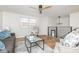 Bright living room featuring hardwood floors, a modern ceiling fan, and stylish furnishings at 7624 Snowflake Dr, Indianapolis, IN 46227