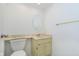 Compact bathroom with a toilet, vanity, sink, and a neutral color palette at 8535 Olde Mill Circle West Dr, Indianapolis, IN 46260