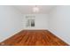 Bright, neutral bedroom with a large window, hardwood floors, and simple lighting fixture at 8535 Olde Mill Circle West Dr, Indianapolis, IN 46260