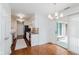 Open dining area with sliding door to the patio and modern chandelier lighting at 8535 Olde Mill Circle West Dr, Indianapolis, IN 46260