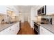 Well-lit kitchen featuring stainless steel appliances, hardwood floors, and white cabinets at 8535 Olde Mill Circle West Dr, Indianapolis, IN 46260
