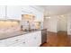 Bright kitchen showcasing white cabinets, stainless steel appliances, and tile backsplash at 8535 Olde Mill Circle West Dr, Indianapolis, IN 46260