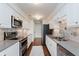Modern kitchen with stainless steel appliances, sleek countertops, and custom backsplash at 8535 Olde Mill Circle West Dr, Indianapolis, IN 46260