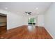 Bright living room with hardwood floors, ceiling fan, and sliding door to porch for seamless indoor-outdoor living at 8535 Olde Mill Circle West Dr, Indianapolis, IN 46260