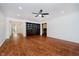 Spacious living room with hardwood floors, built-in shelving, and open access to other rooms in the home at 8535 Olde Mill Circle West Dr, Indianapolis, IN 46260