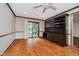Versatile office space featuring hardwood floors, built-in desk and cabinets, and sliding door to the patio at 8535 Olde Mill Circle West Dr, Indianapolis, IN 46260