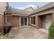 The patio offers an outdoor space with brick walls, a sliding glass door, and a gas grill at 8535 Olde Mill Circle West Dr, Indianapolis, IN 46260