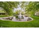 Scenic pond with a fountain and surrounding greenery creates a serene and picturesque setting at 8535 Olde Mill Circle West Dr, Indianapolis, IN 46260