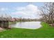 Scenic view of the serene pond surrounded by lush greenery and mature trees at 8535 Olde Mill Circle West Dr, Indianapolis, IN 46260