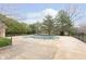 Outdoor pool area featuring a partially-covered pool, large patio, and mature trees at 8535 Olde Mill Circle West Dr, Indianapolis, IN 46260