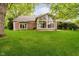 Spacious backyard featuring a sunroom with floor-to-ceiling windows, providing ample natural light at 8535 Olde Mill Circle West Dr, Indianapolis, IN 46260