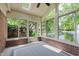 The sunroom features ample natural light and serene views of the pond and landscaping at 8535 Olde Mill Circle West Dr, Indianapolis, IN 46260