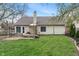 Backyard with a patio area, grassy lawn, and the rear of the home at 8747 Knotty Pine Ct, Indianapolis, IN 46227