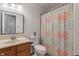 Functional bathroom featuring a vanity, toilet and shower with patterned curtain at 8747 Knotty Pine Ct, Indianapolis, IN 46227
