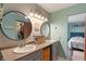 Bright bathroom with double sinks, contemporary mirrors, and access to bedroom and closet at 8747 Knotty Pine Ct, Indianapolis, IN 46227