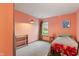 Bright bedroom featuring light fixtures, a window and a built-in shelving unit at 8747 Knotty Pine Ct, Indianapolis, IN 46227