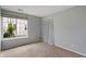 Neutral bedroom showcasing a window with natural light and adjacent closet at 8747 Knotty Pine Ct, Indianapolis, IN 46227