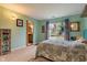 Inviting bedroom with a large window overlooking the backyard and an ensuite bathroom at 8747 Knotty Pine Ct, Indianapolis, IN 46227