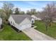 View of the home's exterior highlighting the attached two-car garage and well-kept lawn at 8747 Knotty Pine Ct, Indianapolis, IN 46227