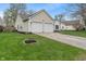 Well-maintained home features a two-car garage and lovely landscaping enhancing the property's appeal at 8747 Knotty Pine Ct, Indianapolis, IN 46227