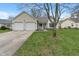 Charming home with a two-car garage and a well-maintained lawn, offering great curb appeal at 8747 Knotty Pine Ct, Indianapolis, IN 46227