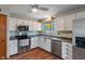 Functional kitchen featuring stainless steel appliances, white cabinets, and great lighting for cooking at 8747 Knotty Pine Ct, Indianapolis, IN 46227