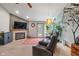 Cozy living room featuring a fireplace, TV, ceiling fan and walkout to the exterior at 8747 Knotty Pine Ct, Indianapolis, IN 46227