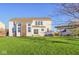 Sprawling backyard with well-maintained lawn, patio, and a view of the two-story home at 8965 Snowberry Ct, Zionsville, IN 46077