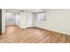 Unfinished basement space featuring wood-look flooring, white trim, and natural light from the window at 8965 Snowberry Ct, Zionsville, IN 46077