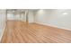 Spacious basement with wood-look flooring, white walls, and access to the staircase and a storage area at 8965 Snowberry Ct, Zionsville, IN 46077