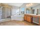 This bathroom features tile floors, a shower, a soaker tub, large vanity and natural light at 8965 Snowberry Ct, Zionsville, IN 46077