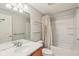 Full bathroom with a combined shower-tub, floating shelves, modern vanity, and neutral walls at 8965 Snowberry Ct, Zionsville, IN 46077