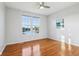 Bedroom with hardwood floors, a ceiling fan, and a picturesque view of a lake at 8965 Snowberry Ct, Zionsville, IN 46077